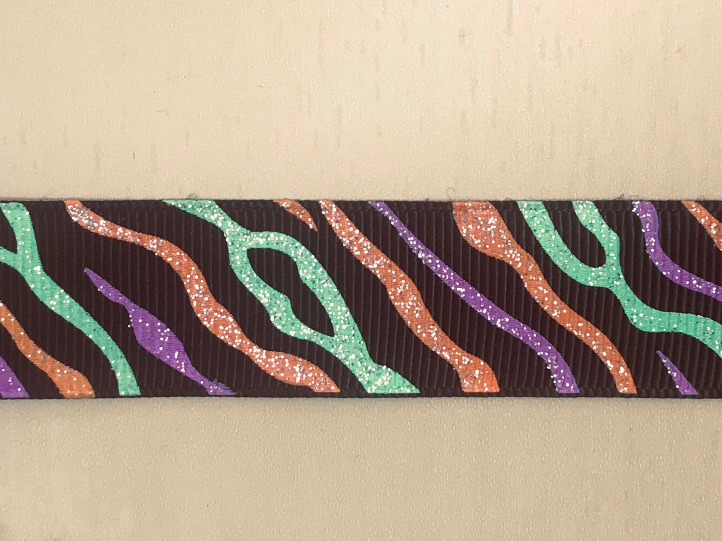 7/8" Wide Black Grosgrain Ribbon With Purple, Orange & Green Zebra Striped Glitter Halloween Colored Print